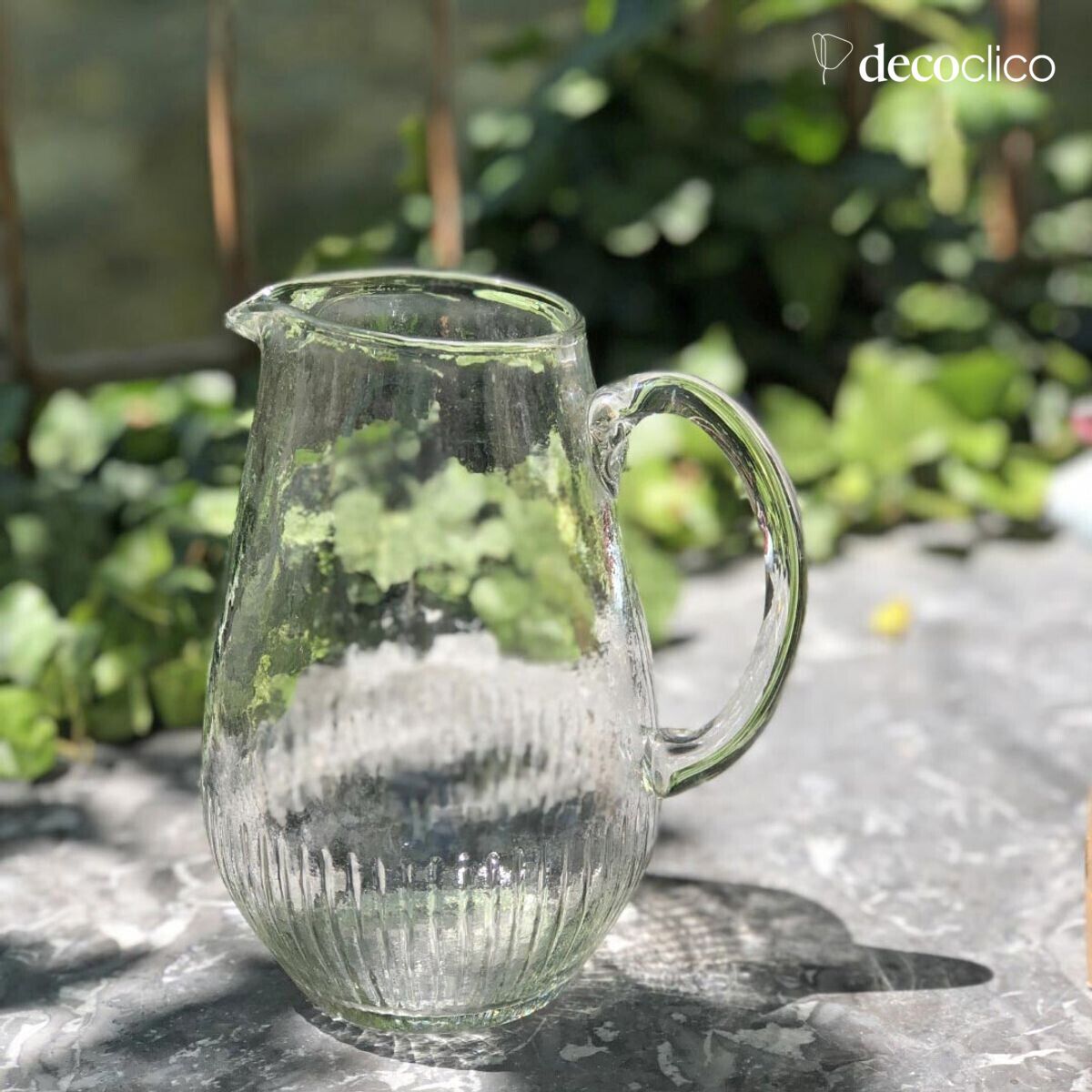 Jug carafe in transparent dappled glass with ribbed base