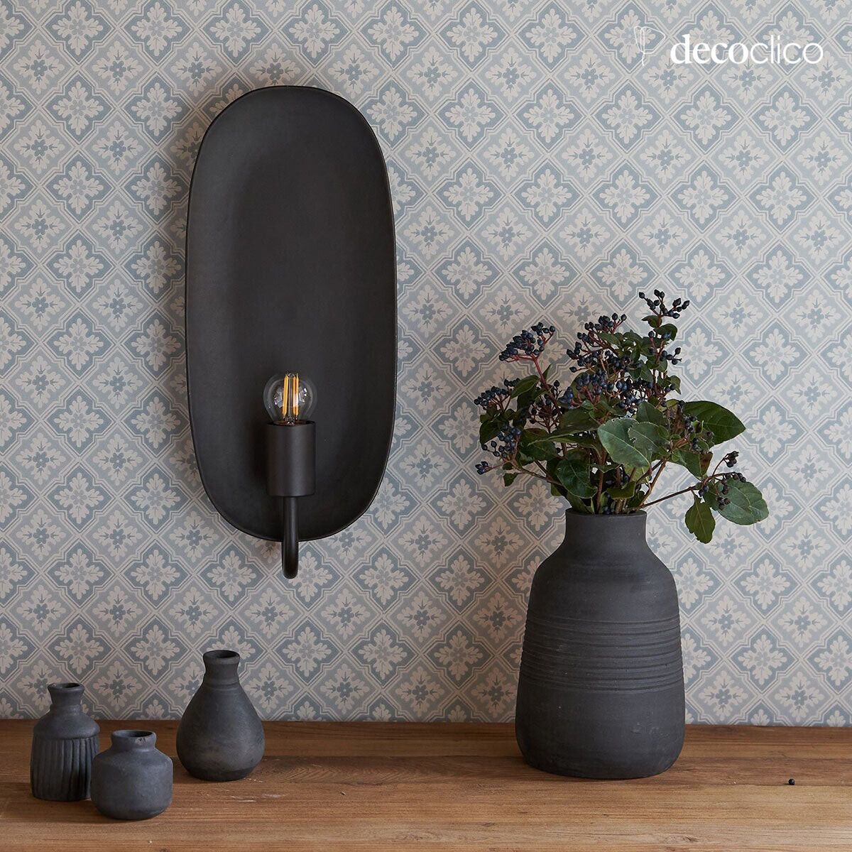 Wall sconce in the style of a candleholder, in metal with a matt black finish